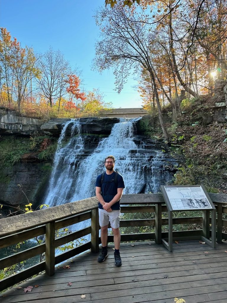 Cuyahoga Valley National Park in the Fall: Our 2-Day Trip Dylan standing in front of Brandywine Falls in Cuyahoga Valley National Park