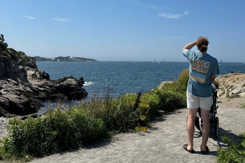 Rhode Island Family Vacation: Our 4-Day Narragansett Itinerary Dylan wearing a Block Island T-shirt along the rocky coast of Conanicut Island