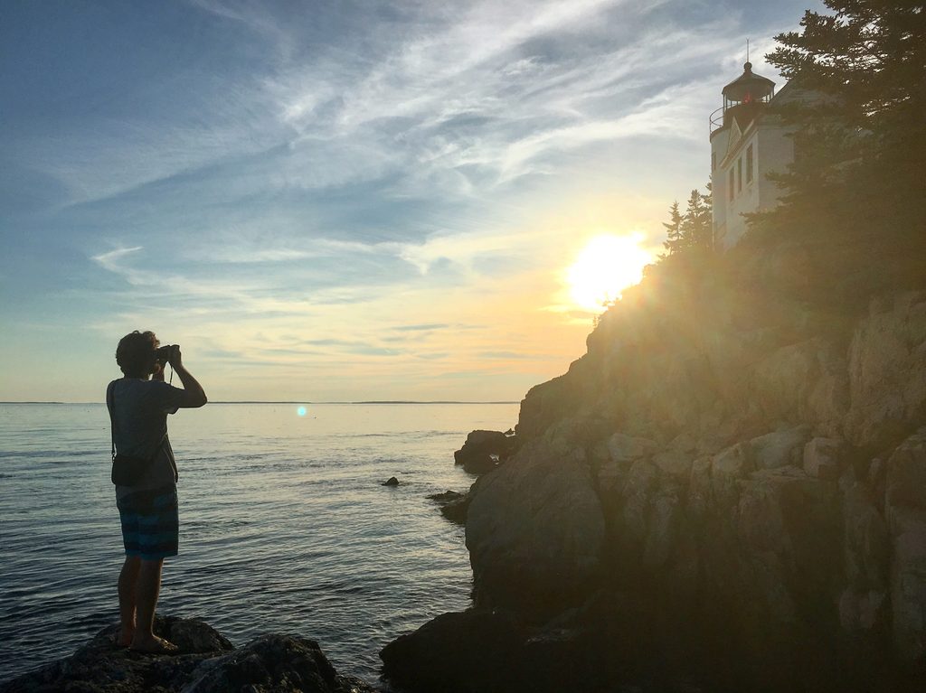 3-Day Acadia National Park Camping Itinerary Dylan photographing the sunset at Bass Harbor Head Light Station in Acadia National Park.