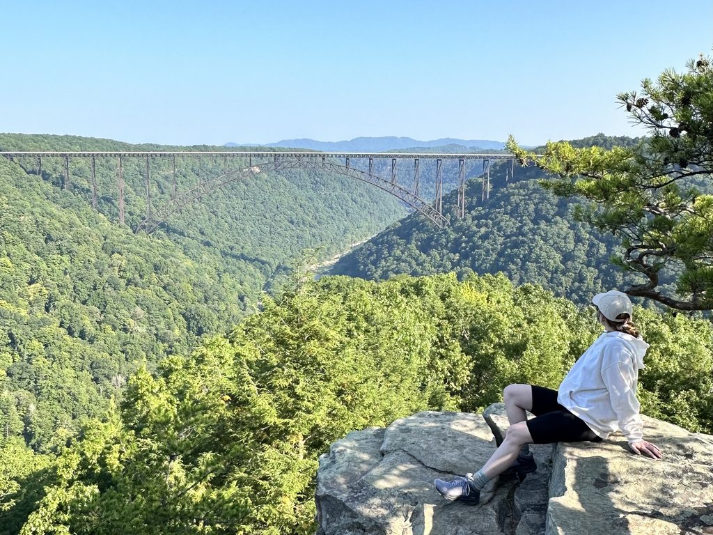 2 Days in New River Gorge National Park Hannah sitting on the rocks at Long Point in New River Gorge National Park
