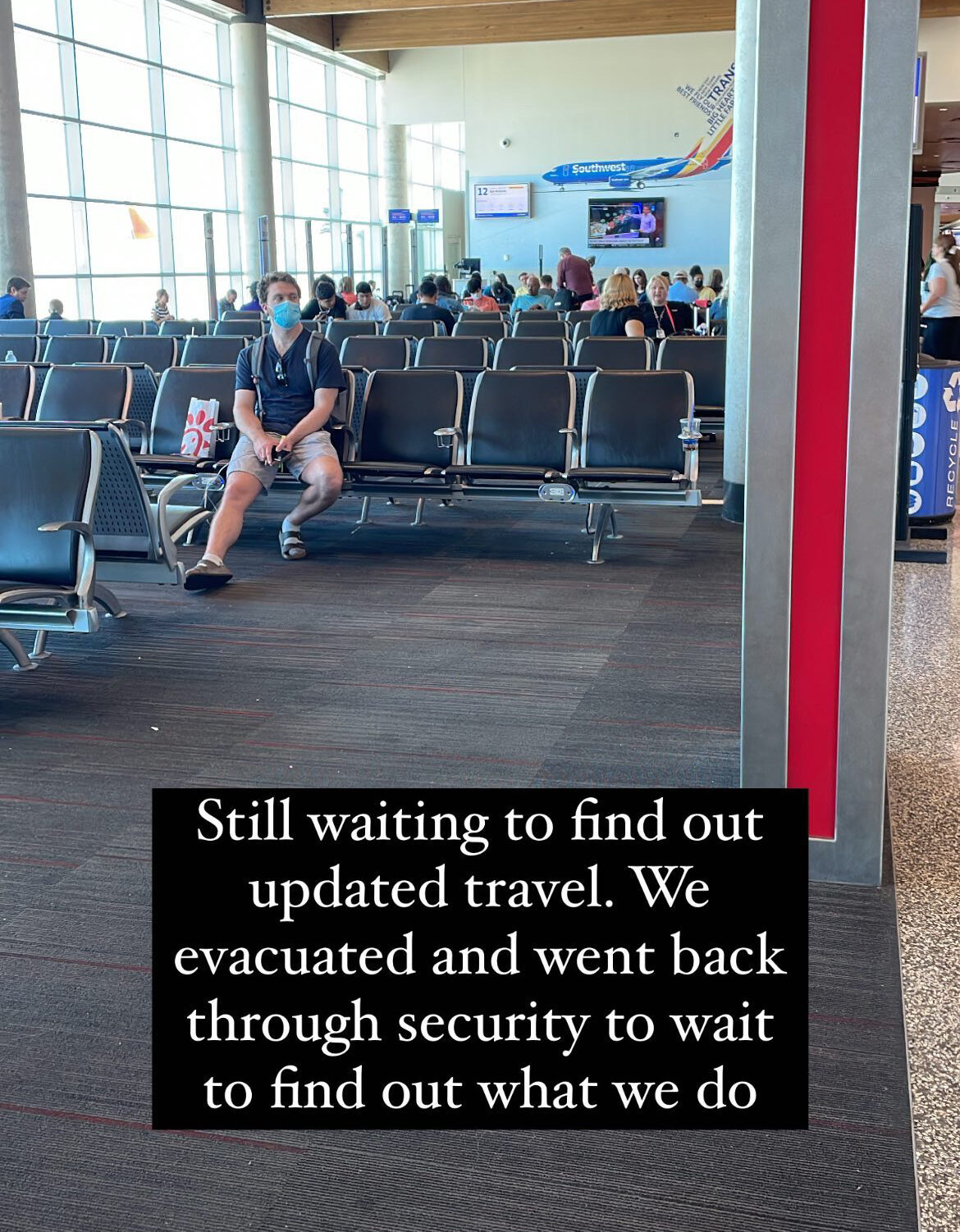 7-Day Utah Itinerary: Salt Lake City, Zion & Bryce Canyon National Parks Dylan sitting on the chairs at the Dallas Love Field airport with on screen text "Still waiting to find out updated travel. We evacuated and went back through security to wait to find out what we do."